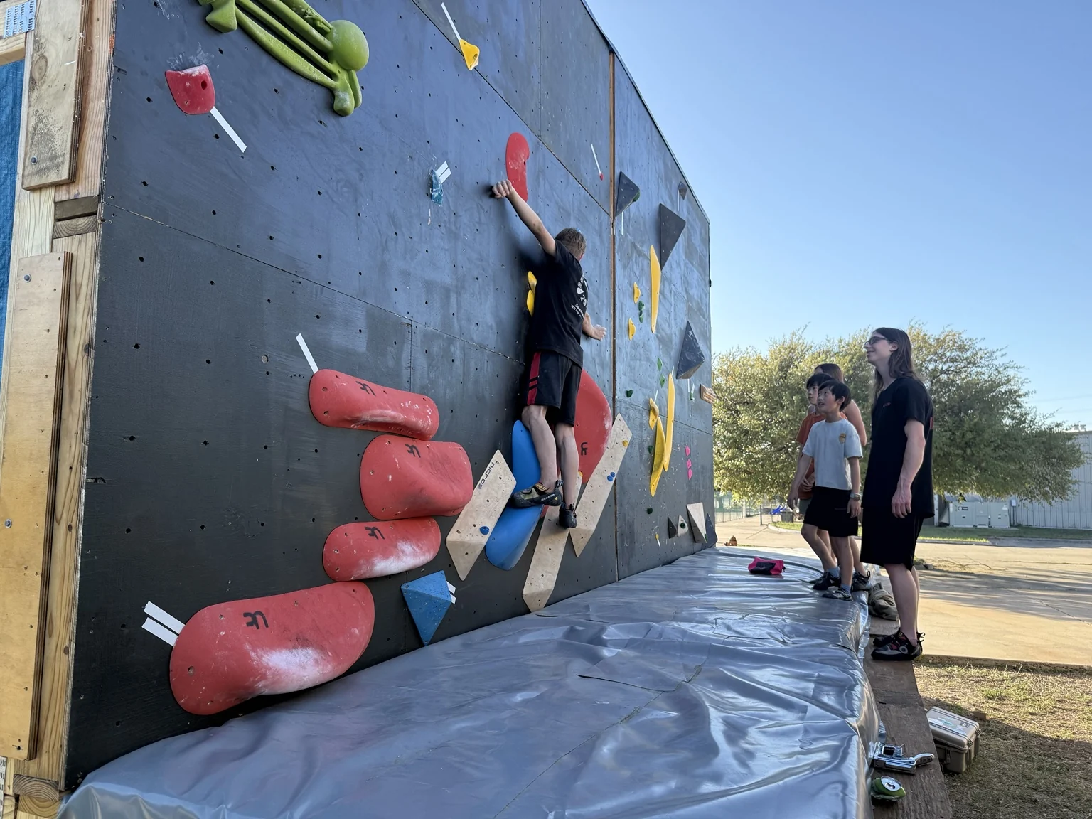 Athletes training on an outdoor climbing wall